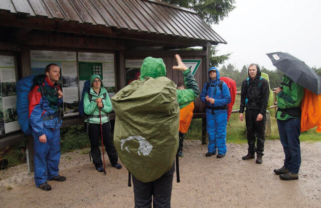 "The picture shows a nature guide conducting a tour in sign language. "
